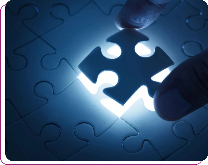 A person is holding the missing piece of a puzzle.